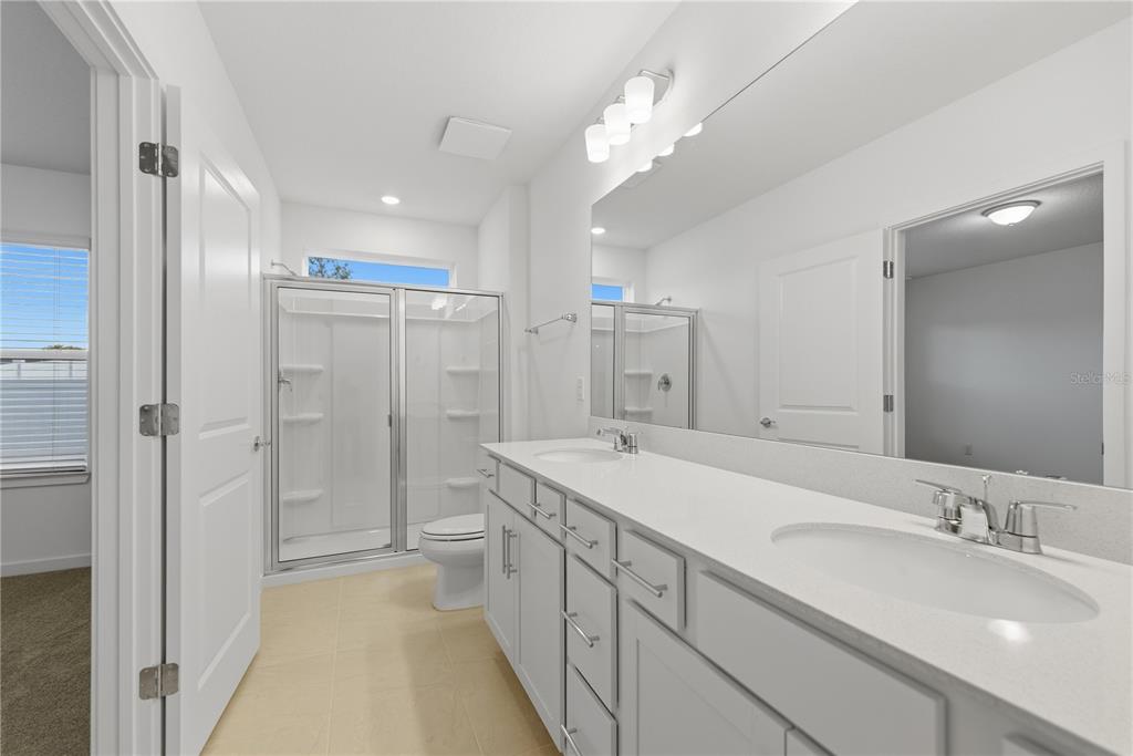 6760 Southwest 90th Loop Ocala, FL 34476 - Photo 17 of 28 a spacious bathroom with a double vanity sink mirror and shower