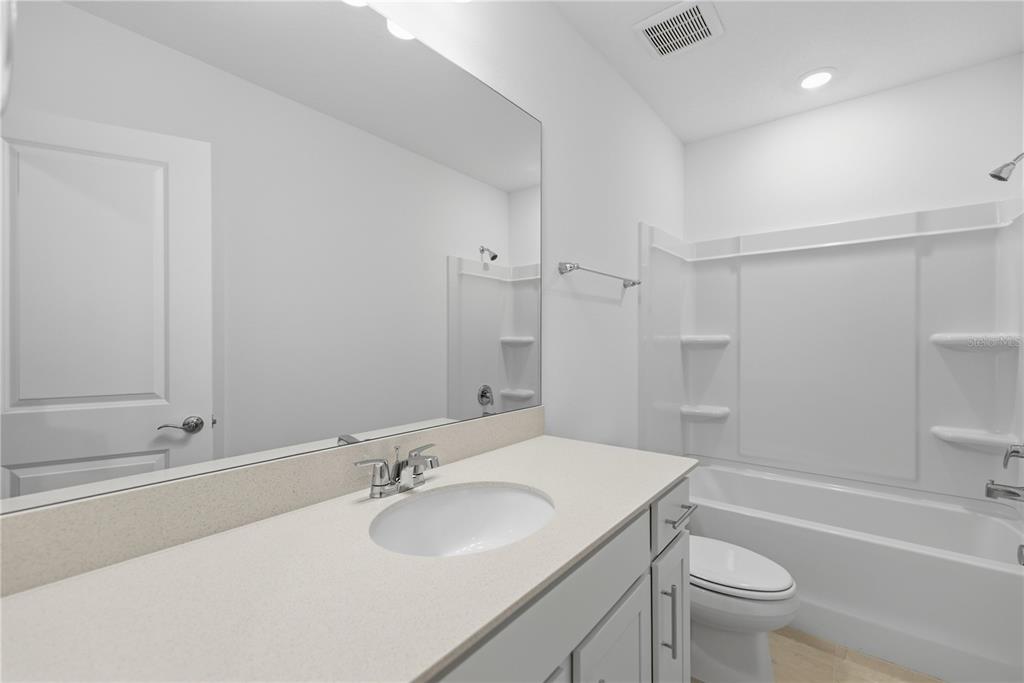 6760 Southwest 90th Loop Ocala, FL 34476 - Photo 21 of 28 a bathroom with a sink toilet vanity and shower