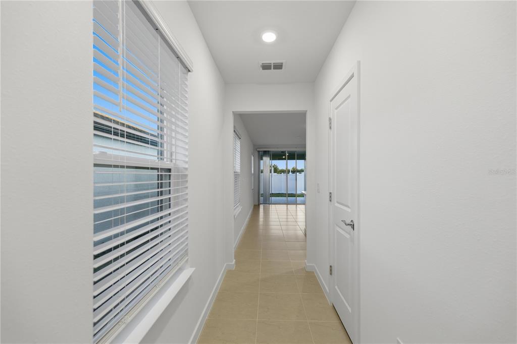 6760 Southwest 90th Loop Ocala, FL 34476 - Photo 8 of 28 a view of a hallway with wooden floor and staircase