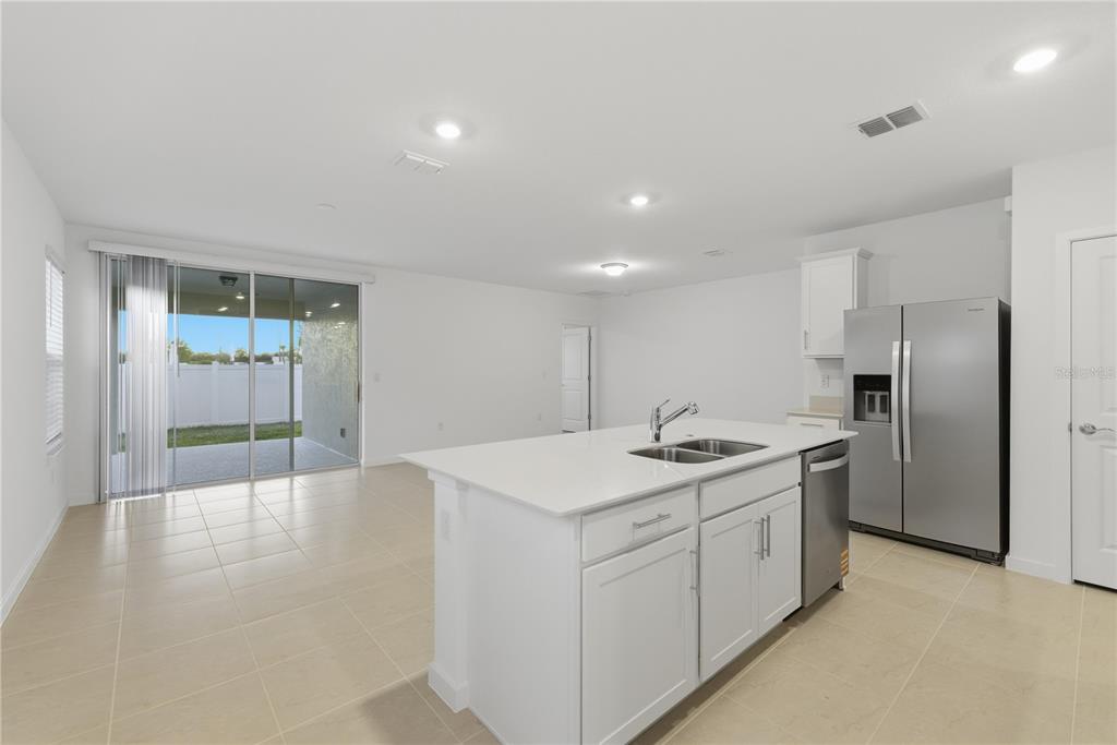 6760 Southwest 90th Loop Ocala, FL 34476 - Photo 9 of 28 a kitchen with a sink stove and refrigerator