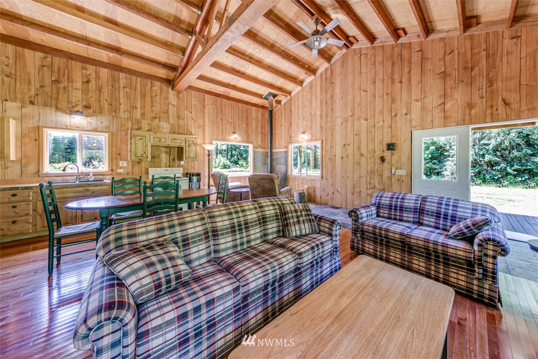 3386 Undi Road Forks, WA 98331 - Photo 20 of 36 a living room with furniture a large window and wooden floor