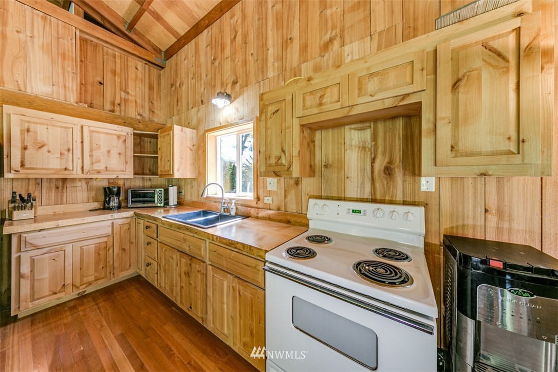 3386 Undi Road Forks, WA 98331 - Photo 23 of 36 a kitchen with a stove a sink and a refrigerator