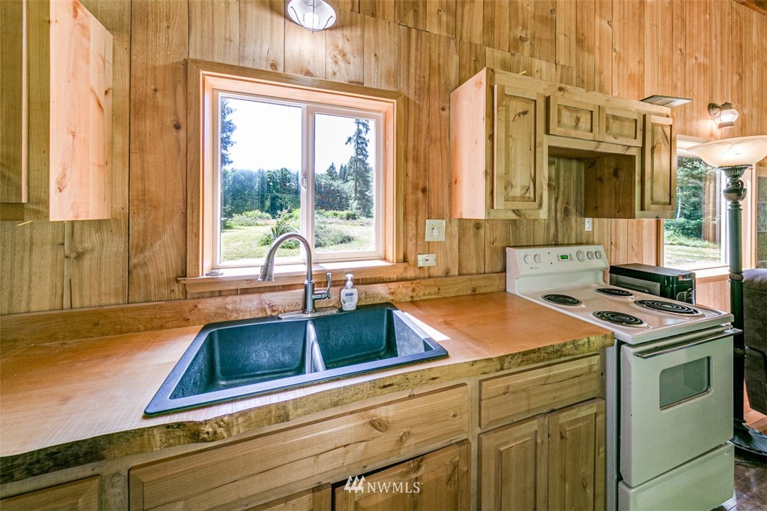 3386 Undi Road Forks, WA 98331 - Photo 24 of 36 a kitchen that has a sink and a stove next to a window