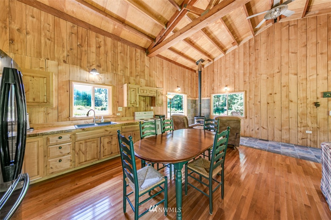 3386 Undi Road Forks, WA 98331 - Photo 25 of 36 a dining room with furniture a rug a chandelier and wooden floor