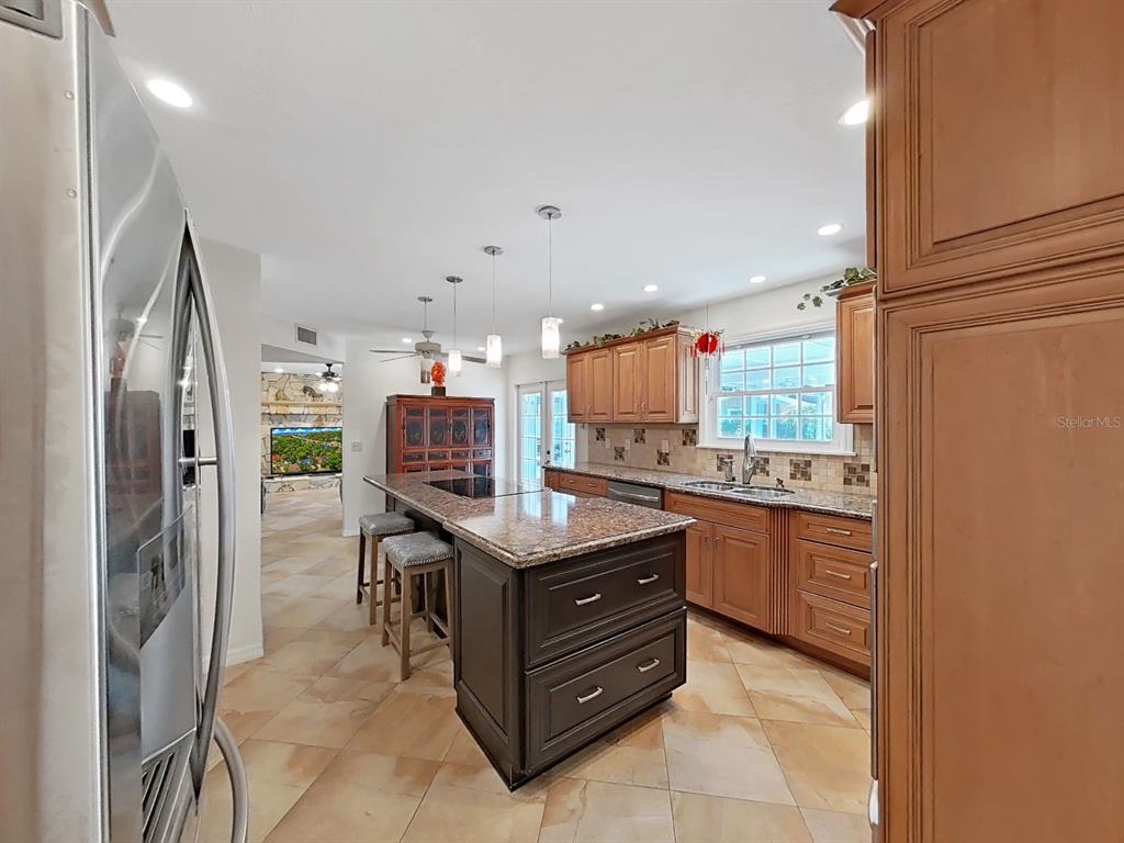 7645 Harborview Way Seminole, FL 33776 - Photo 12 of 55 a kitchen with stainless steel appliances granite countertop a refrigerator and a stove