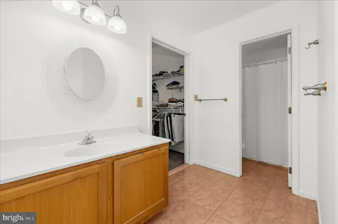 a bathroom with a tub a sink and a window