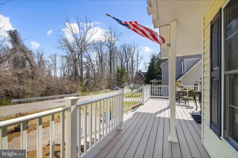 a living room with furniture a rug potted plant and a large window