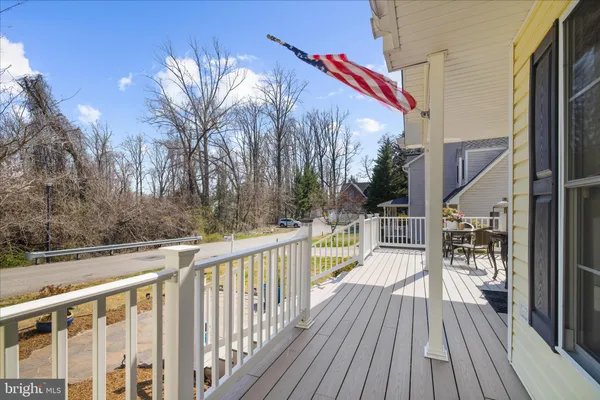 a living room with furniture a rug potted plant and a large window