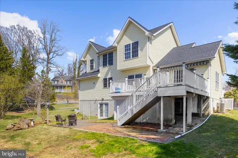 a view of a house with yard and sitting area