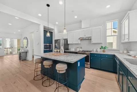 a kitchen with stainless steel appliances granite countertop counter space a sink refrigerator and cabinets