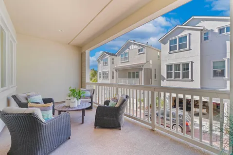 a balcony with furniture and wooden floor
