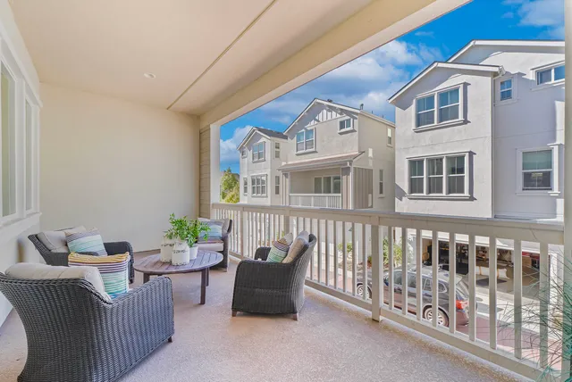a balcony with furniture and wooden floor