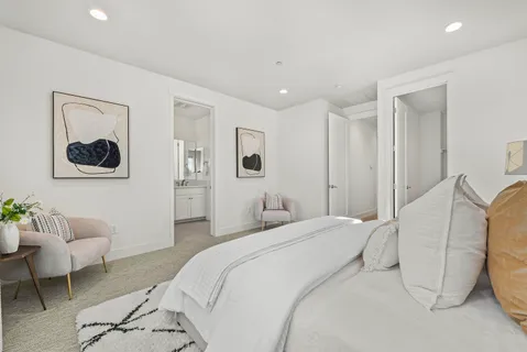 a bedroom with a bed and a couch