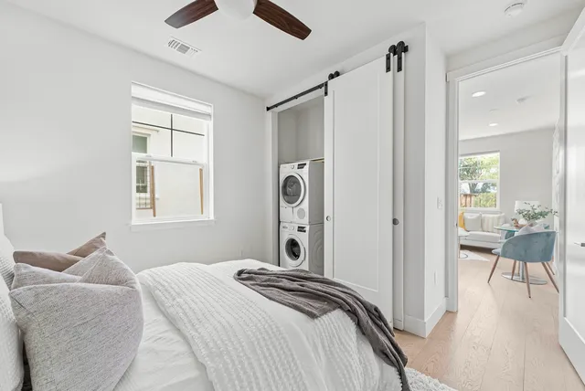 a bedroom with a bed and a chandelier