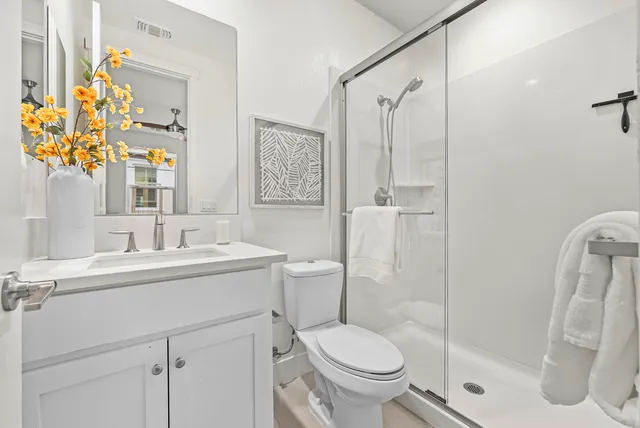 a bathroom with a sink toilet and shower