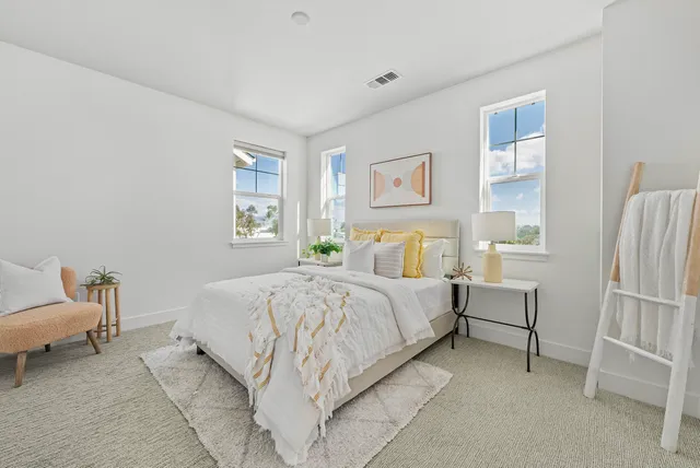 a bedroom with a bed and a chair