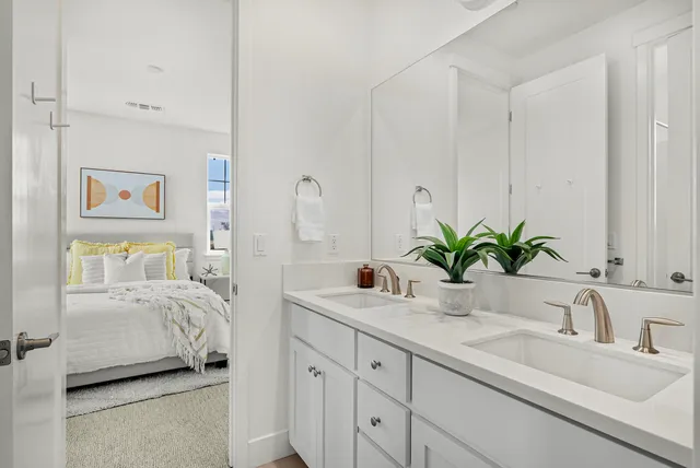 a bathroom with a granite countertop toilet a sink and a shower