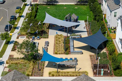 an aerial view of multiple houses with a street