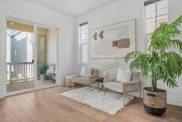a living room with furniture and a potted plant