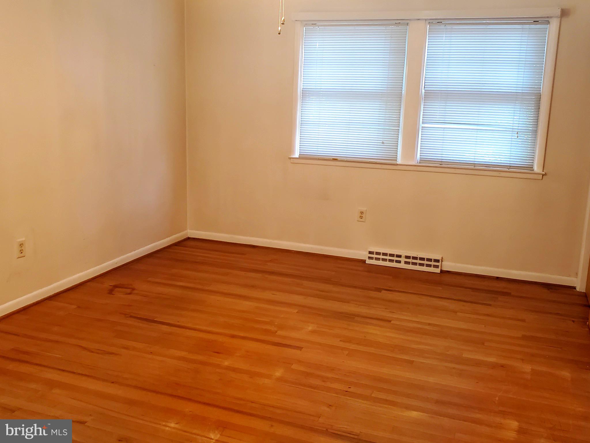 3010 Curtis Road Reading, PA 19608 - Photo 4 of 14 an empty room with wooden floor and windows