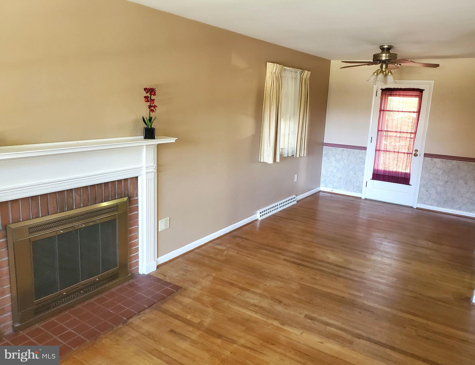 3010 Curtis Road Reading, PA 19608 - Photo 5 of 14 wooden floor fireplace and windows in an empty room