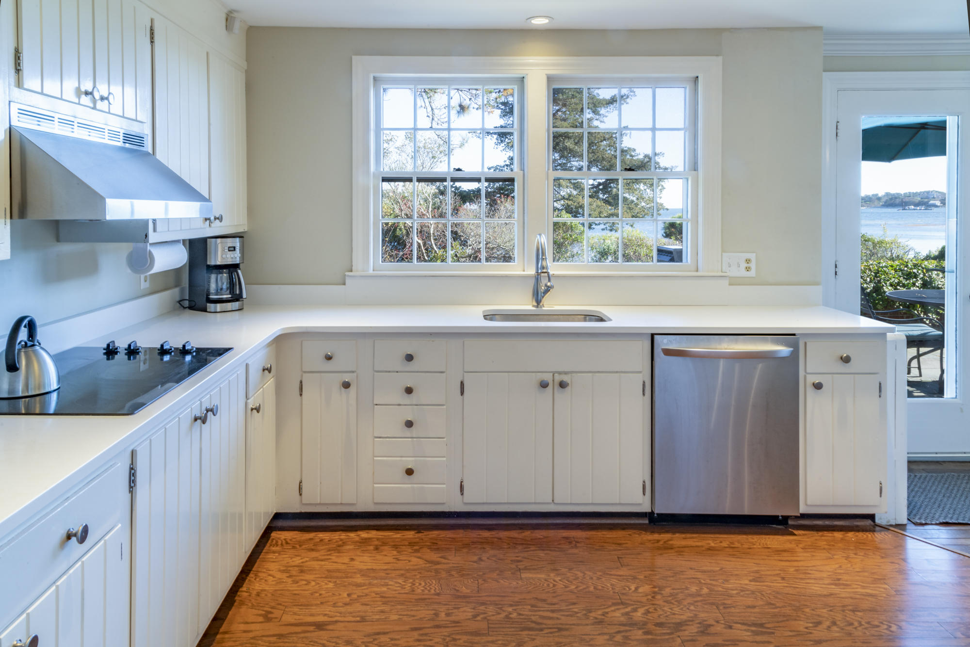 132 Old Salt Works Road Chatham, MA 02633 - Photo 13 of 34 a kitchen with stainless steel appliances granite countertop a sink window and cabinets