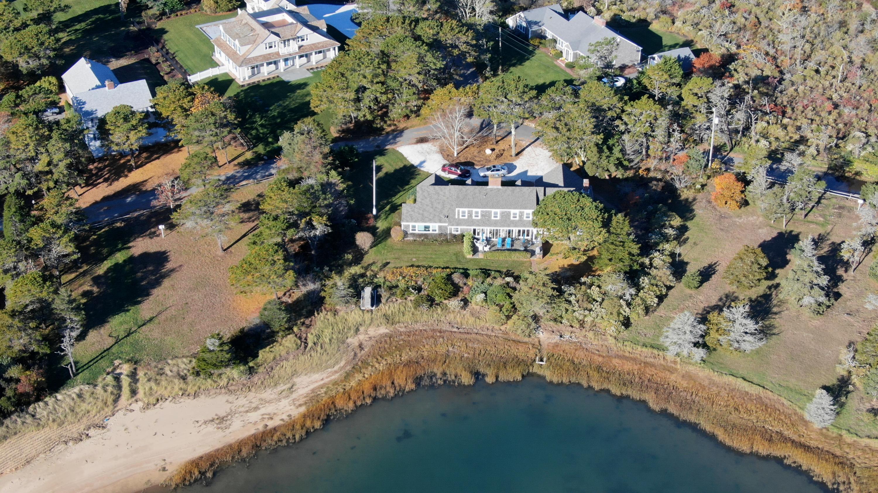 132 Old Salt Works Road Chatham, MA 02633 - Photo 31 of 34 an aerial view of a house with a yard and lake view