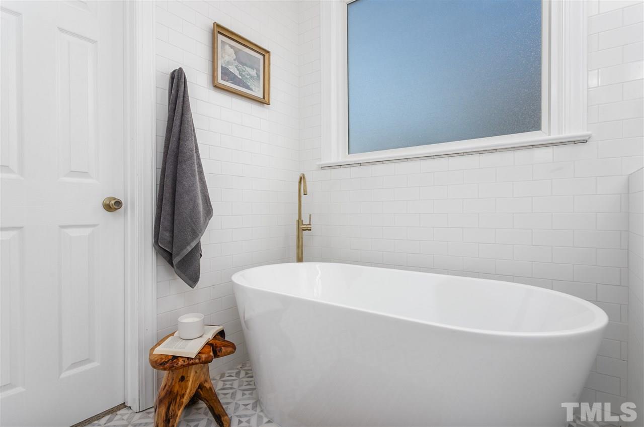 608 Hardimont Road Raleigh, NC 27609 - Photo 16 of 29 a white bath tub sitting next to a white toilet and vanity