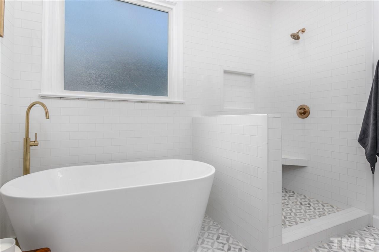608 Hardimont Road Raleigh, NC 27609 - Photo 17 of 29 a white bath tub sitting in a bathroom