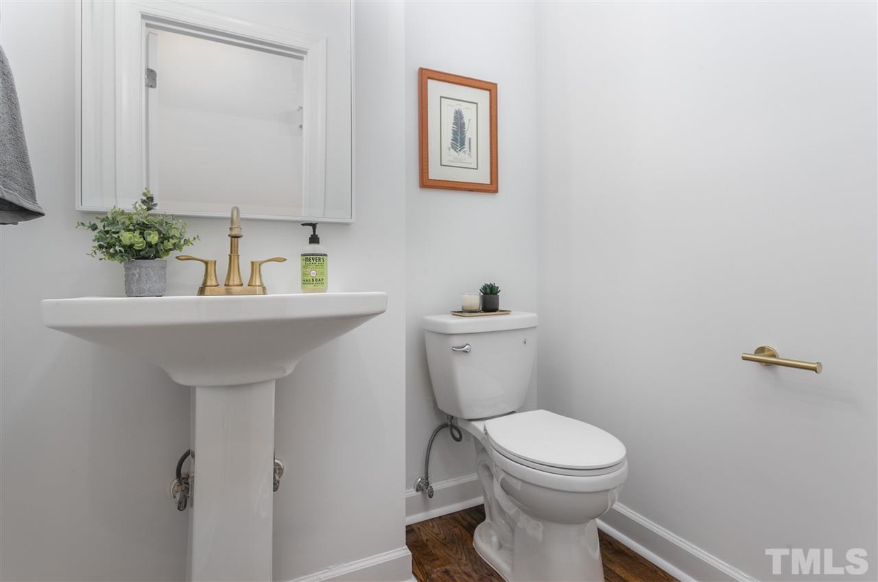 608 Hardimont Road Raleigh, NC 27609 - Photo 20 of 29 a bathroom with a toilet a sink and mirror