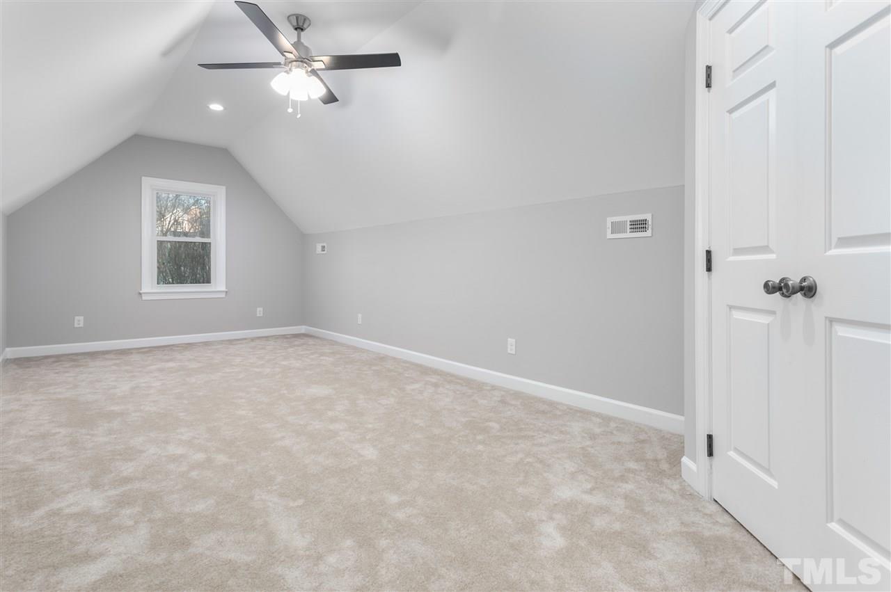608 Hardimont Road Raleigh, NC 27609 - Photo 22 of 29 an empty room with windows and fan