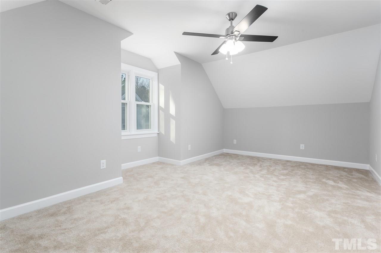 608 Hardimont Road Raleigh, NC 27609 - Photo 24 of 29 an empty room with chandelier fan and windows
