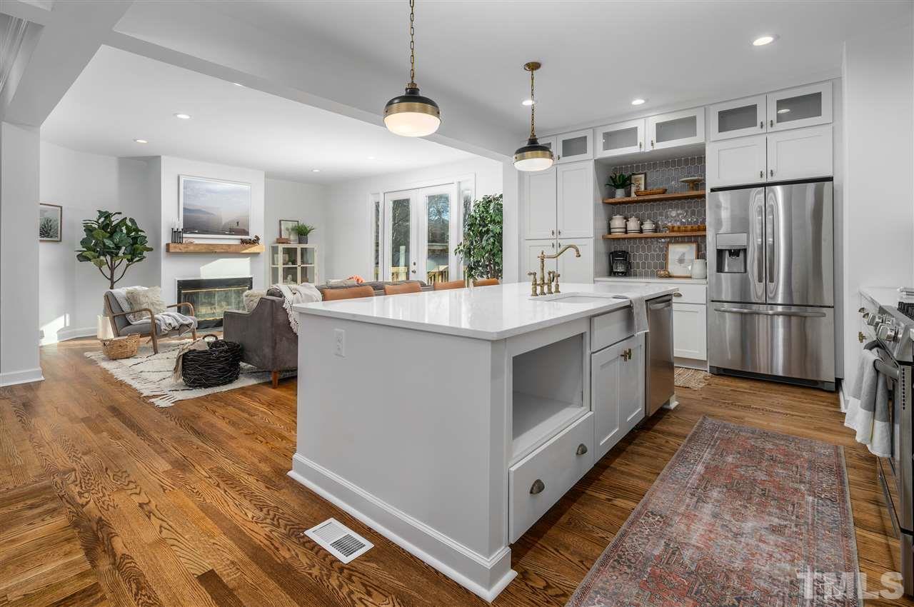608 Hardimont Road Raleigh, NC 27609 - Photo 10 of 29 a large kitchen with kitchen island a large counter top space a sink stainless steel appliances and cabinets