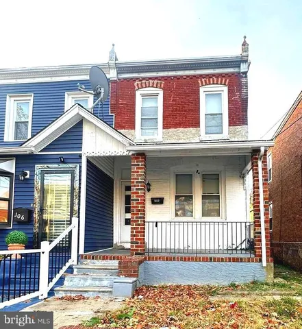 a view of a house with wooden fence