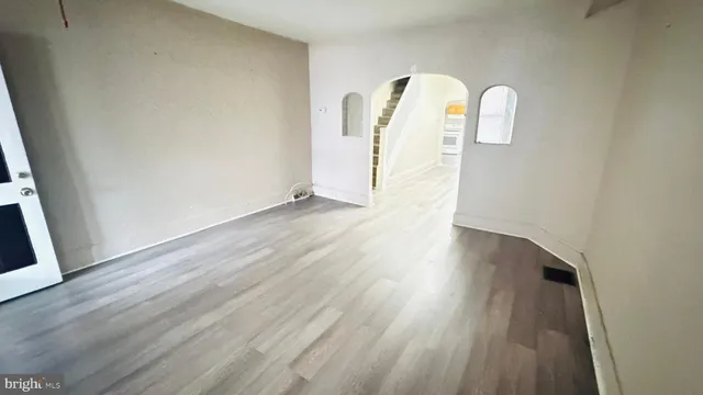 a view of a room with wooden floor
