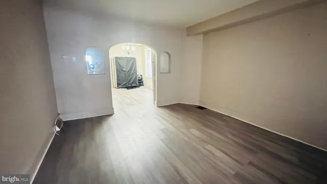 a view of a room with wooden floor