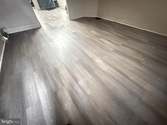 a view of an empty room and wooden floor