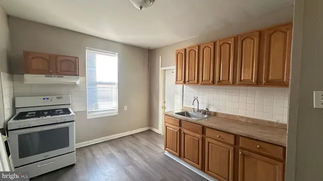 a kitchen that has a sink and a stove