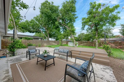 a view of backyard with seating area and green space