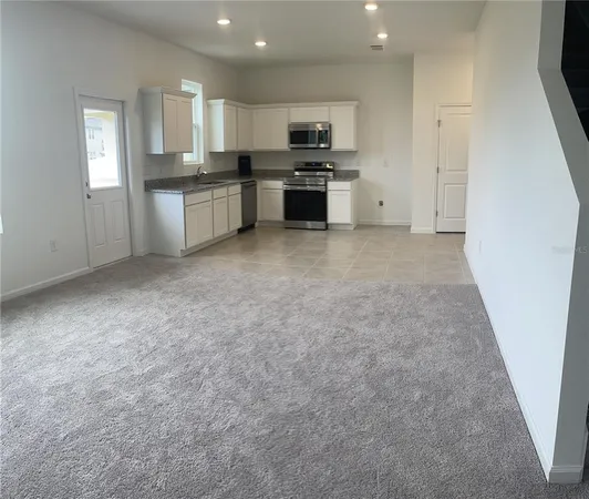 a kitchen with a refrigerator stove and microwave