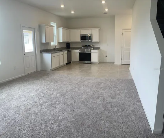 a kitchen with a refrigerator stove and microwave
