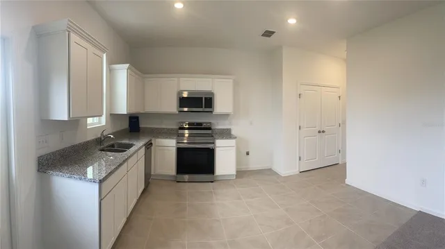 a kitchen with a sink cabinets and a window