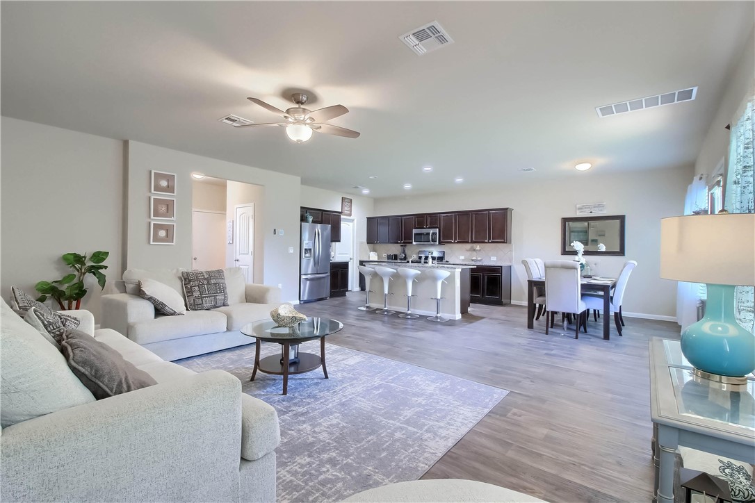 a living room with furniture and kitchen view