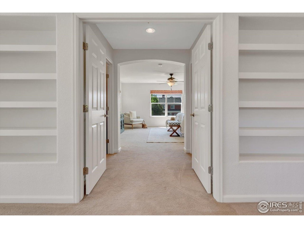 4119 Riley Drive Longmont, CO 80503 - Photo 22 of 47 Built-in bookcases frame the double door entrance to the Primary Suite