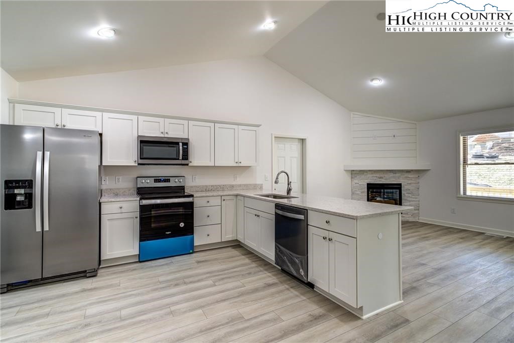 21 Townhomes Place, Unit 21 Boone, NC 28607 - Photo 11 of 19 a kitchen with stainless steel appliances a stove a sink and a refrigerator