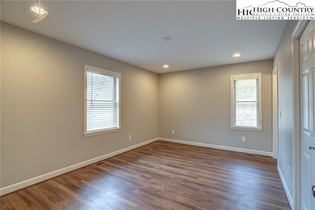 21 Townhomes Place, Unit 21 Boone, NC 28607 - Photo 14 of 19 an empty room with wooden floor and windows