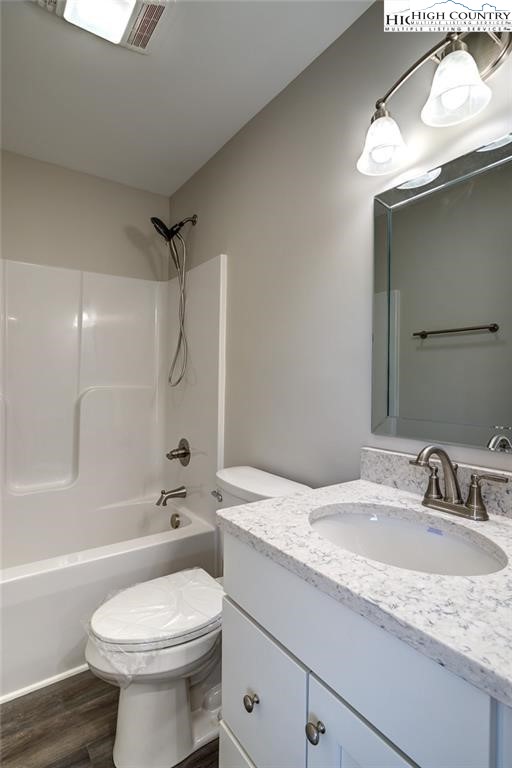 21 Townhomes Place, Unit 21 Boone, NC 28607 - Photo 16 of 19 a bathroom with a granite countertop toilet sink and mirror