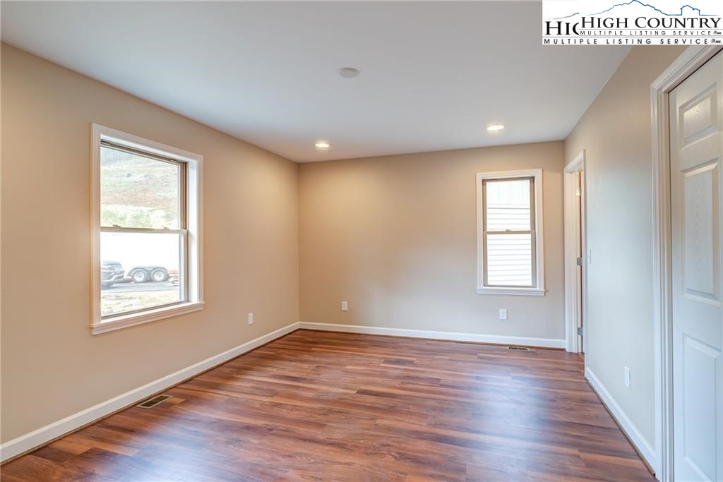 21 Townhomes Place, Unit 21 Boone, NC 28607 - Photo 18 of 19 a view of an empty room with wooden floor and a window