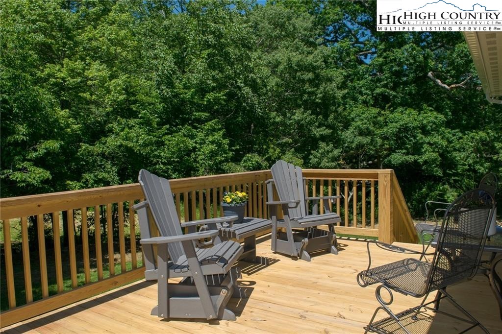 21 Townhomes Place, Unit 21 Boone, NC 28607 - Photo 2 of 19 a view of roof deck with chairs and wooden fence
