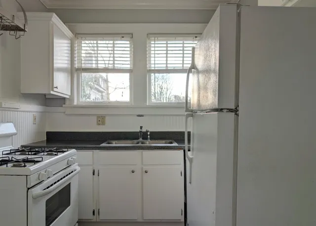 a kitchen with a sink stove and cabinets
